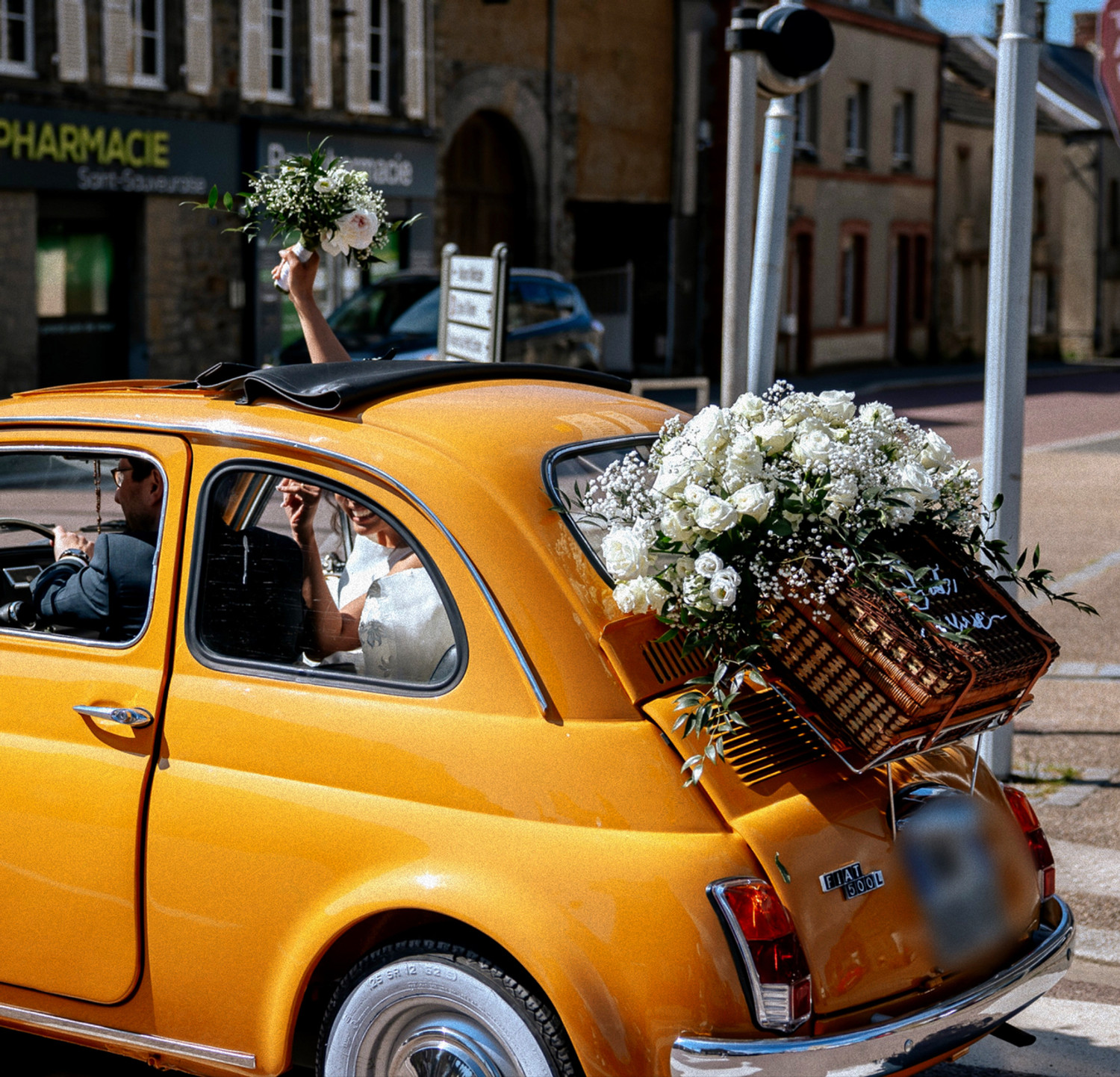 Voiture orange ornée de fleurs blanches